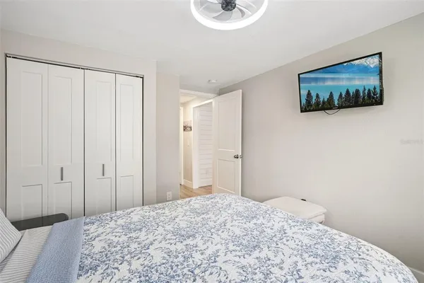 a bedroom with a bed and a painting on the wall