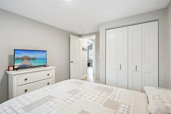 a bedroom with a bed and a dresser in it