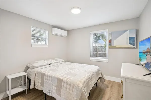 a bedroom with a bed and a window
