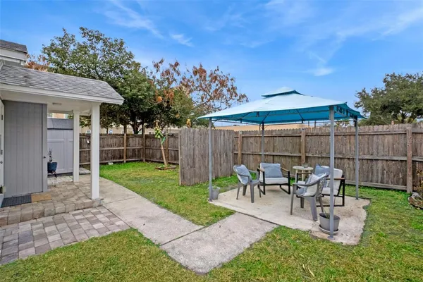 a view of a patio with a table and chairs