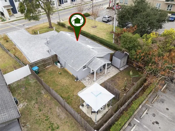 an aerial view of a house with a yard