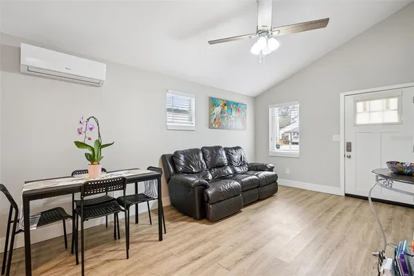 a living room with furniture and a wooden floor