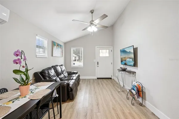 a living room with furniture and wooden floor