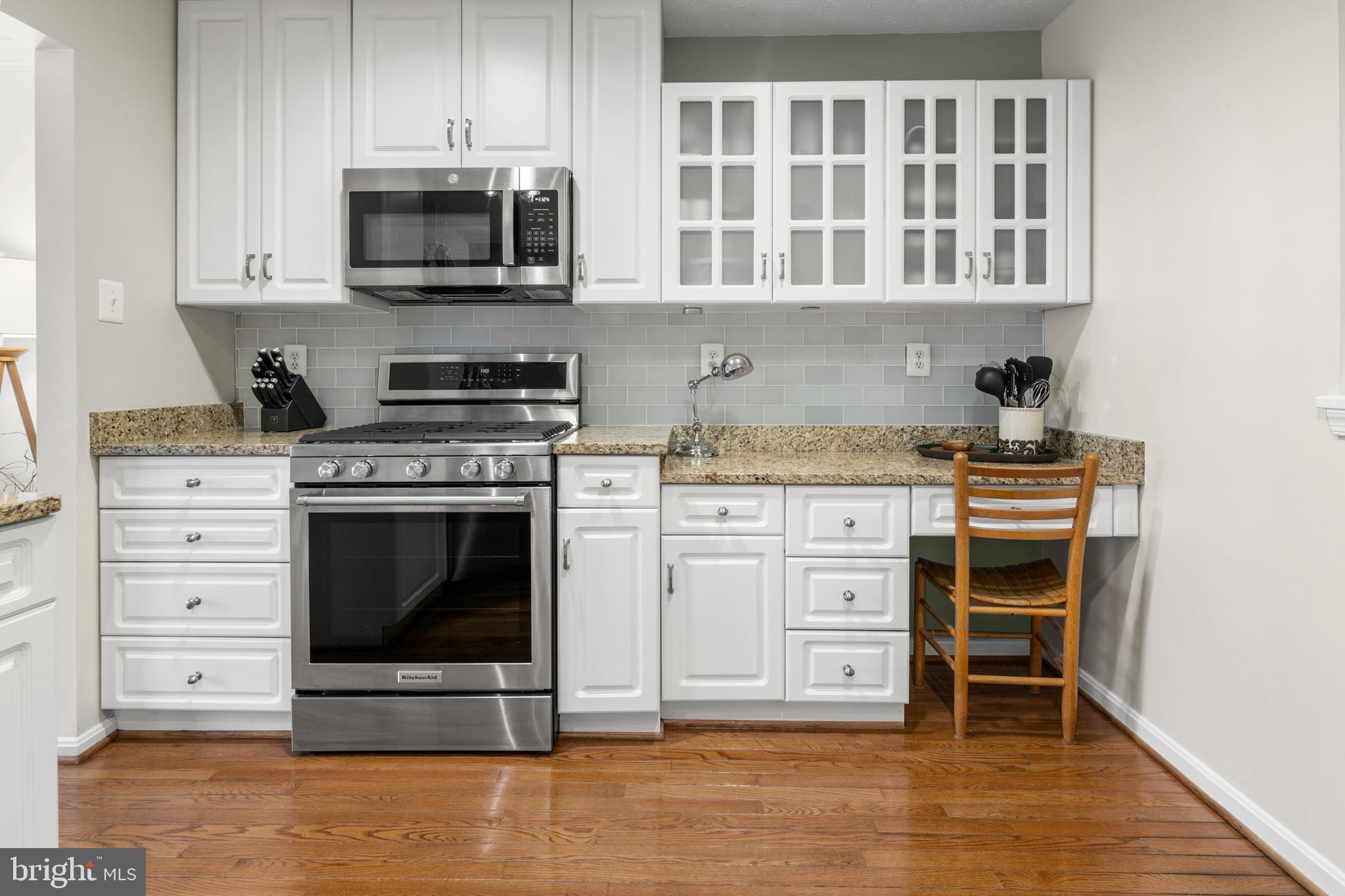 1447 Falcon Nest Court, Unit 45 Arnold, MD 21012 - Photo 14 of 58 a kitchen with stainless steel appliances granite countertop a stove microwave and cabinets