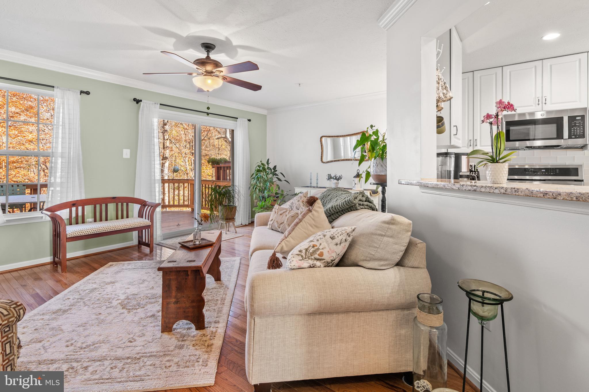 1447 Falcon Nest Court, Unit 45 Arnold, MD 21012 - Photo 30 of 58 a living room with furniture fireplace and a large window
