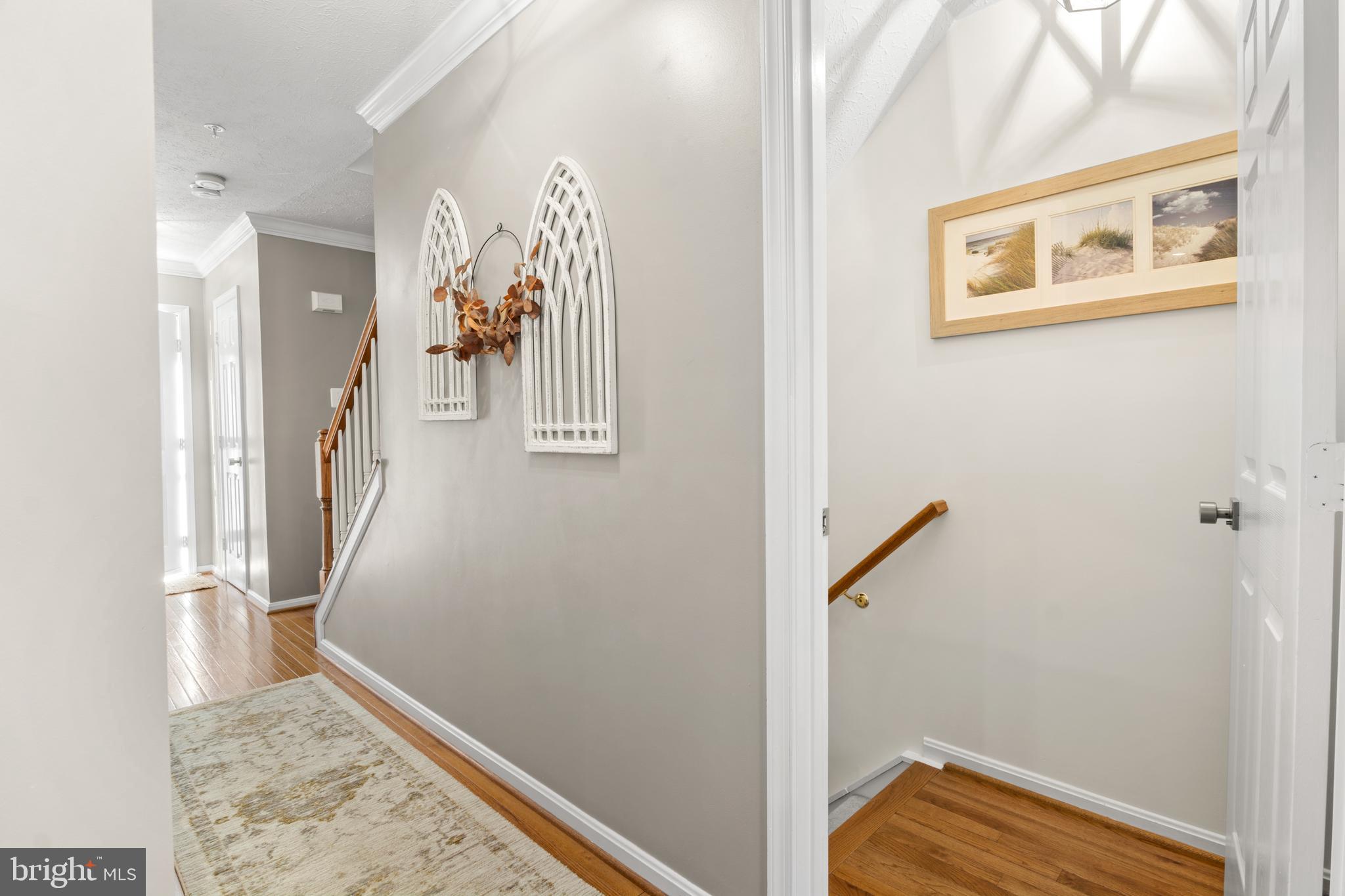1447 Falcon Nest Court, Unit 45 Arnold, MD 21012 - Photo 32 of 58 a view of a hallway with paintings on the wall