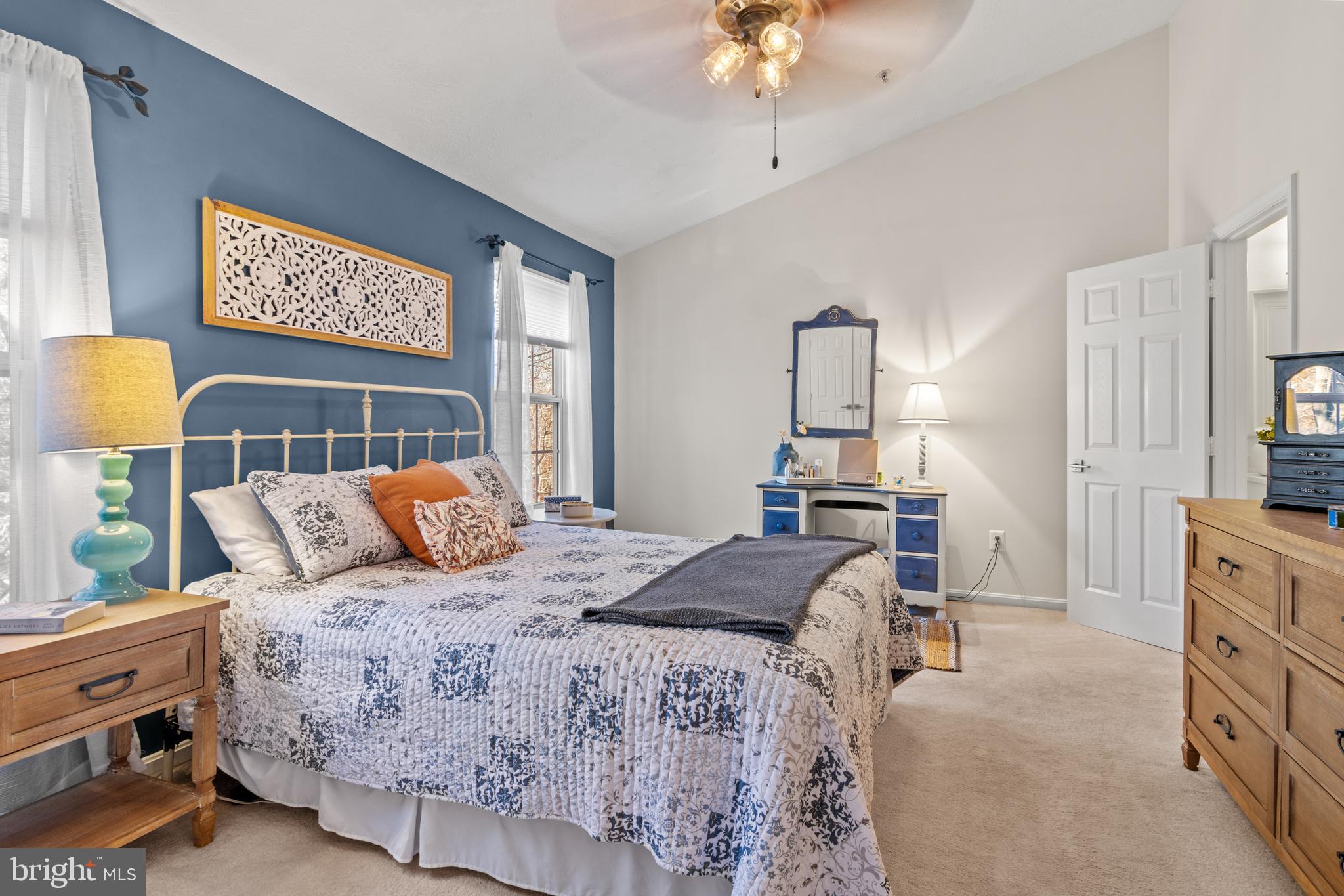 1447 Falcon Nest Court, Unit 45 Arnold, MD 21012 - Photo 34 of 58 a bedroom with a bed a chandelier and dresser