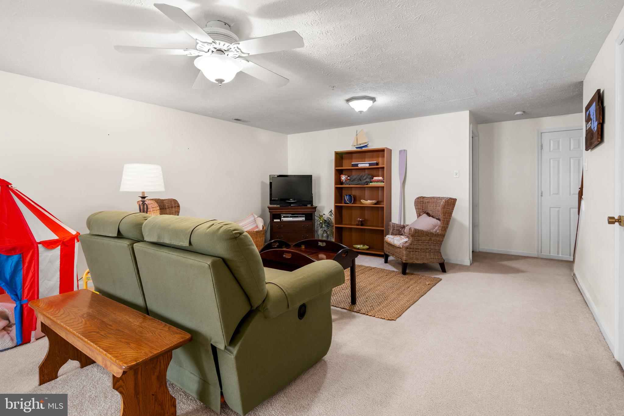 1447 Falcon Nest Court, Unit 45 Arnold, MD 21012 - Photo 47 of 58 a living room with furniture and a chandelier