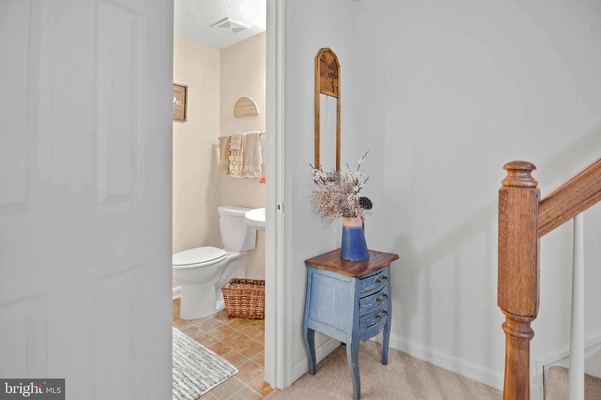 1447 Falcon Nest Court, Unit 45 Arnold, MD 21012 - Photo 51 of 58 a bathroom with a toilet sink and shower curtain
