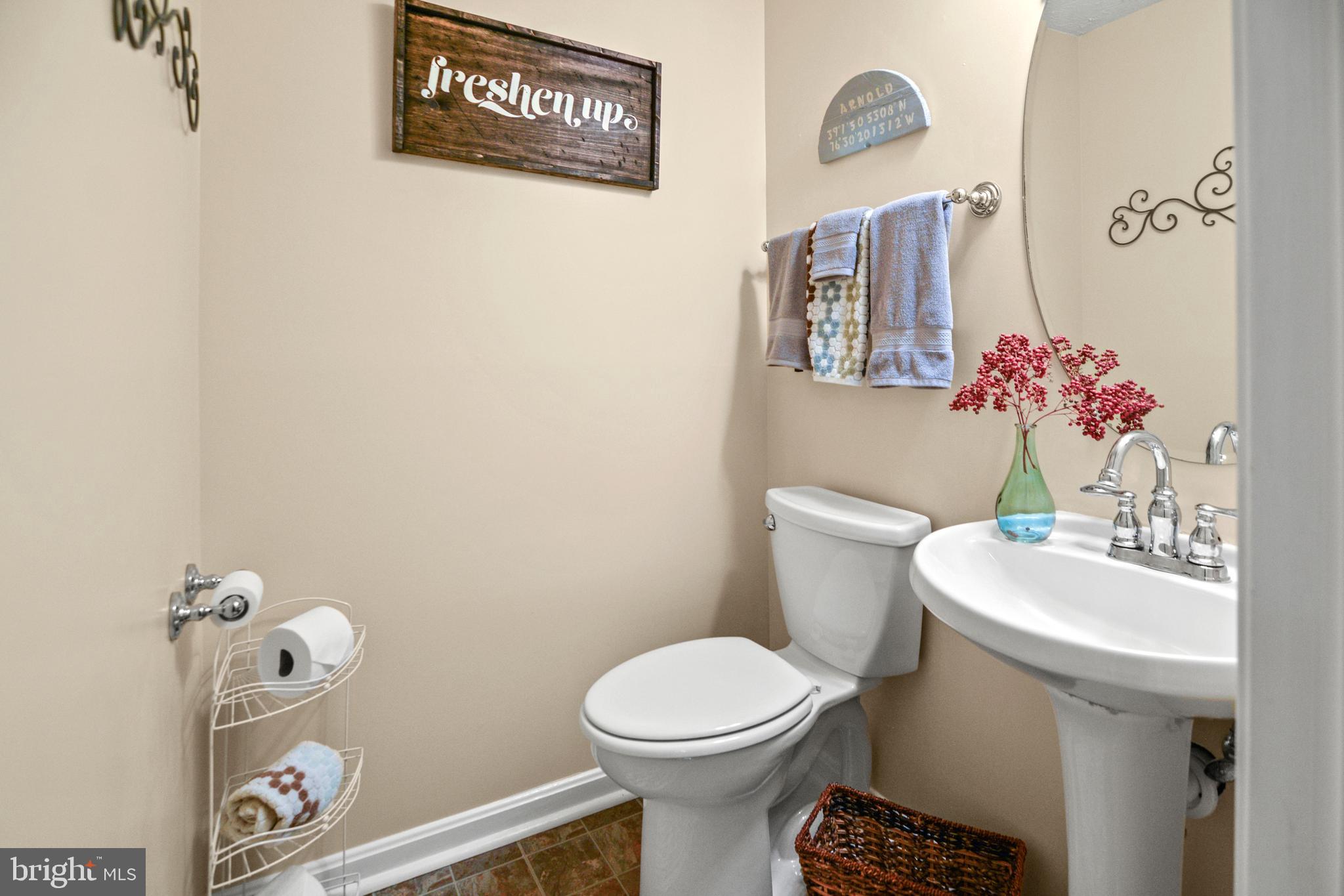 1447 Falcon Nest Court, Unit 45 Arnold, MD 21012 - Photo 52 of 58 a bathroom with a toilet a sink and a mirror