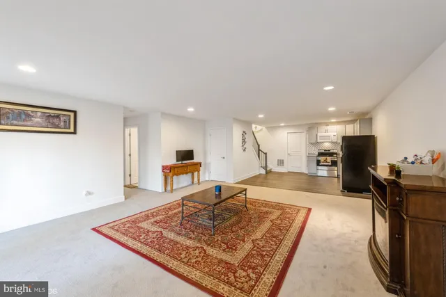 a living room with stainless steel appliances furniture or couch