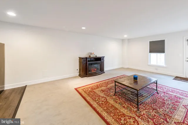 a living room with a couch and a rug