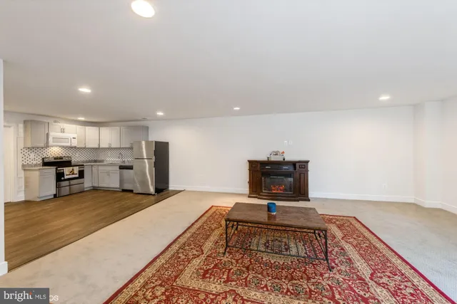 a living room with furniture and a rug