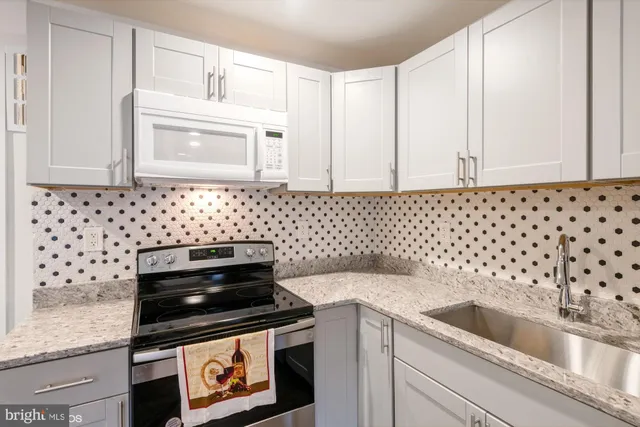 a kitchen with a sink stove and cabinets