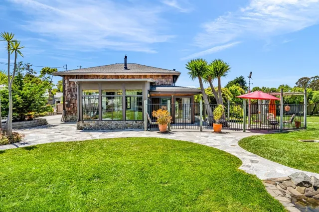 a view of a house with swimming pool and sitting area