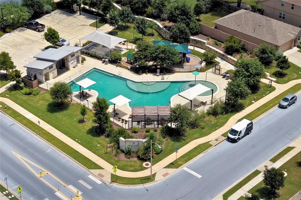 7225 Ranchito Drive Austin, TX 78744 - Photo 38 of 40 An aerial view shows community amenities including a swimming pool, playground, and basketball court.