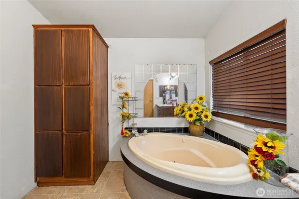 a bathroom with a sink a potted plant and a shower