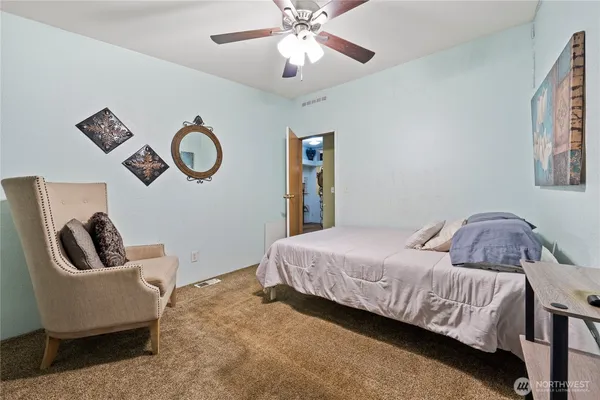 a bedroom with a bed and ceiling fan