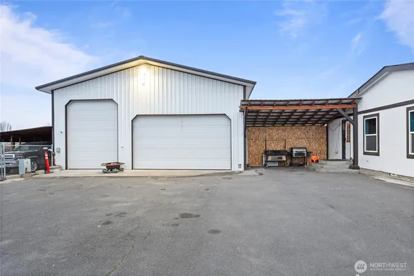 a view of a house with large windows and a garage