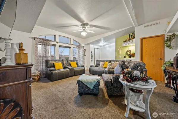 a living room with furniture and a chandelier