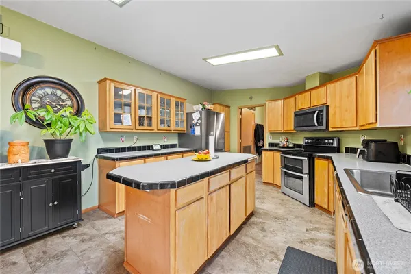 a kitchen with a stove a sink and a refrigerator