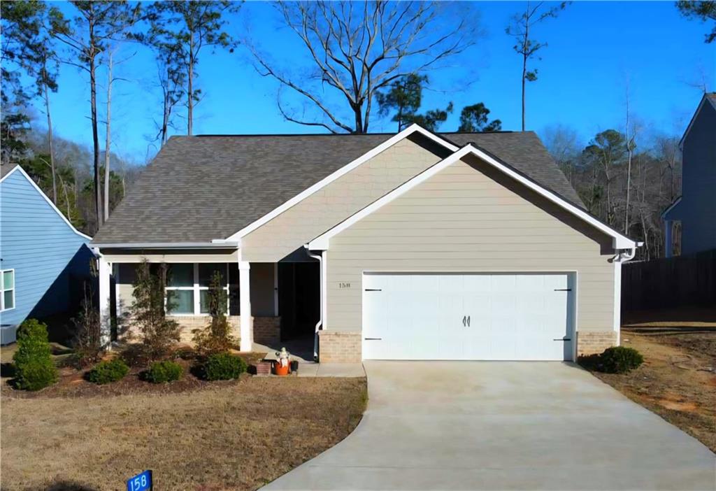 158 Savannah Way Milner, GA 30257 - Photo 1 of 1 a view of a house with a garage