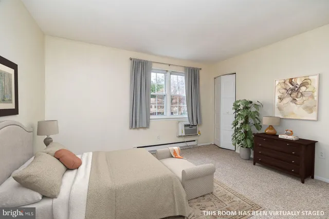 a bedroom with furniture and a window