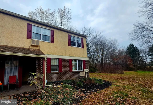 a view of a house with yard and sitting area
