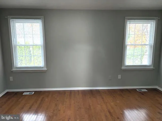 a view of a room with wooden floor and window