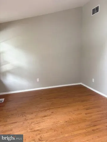 a view of an empty room and wooden floor