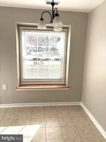 a view of a kitchen that has a sink and window