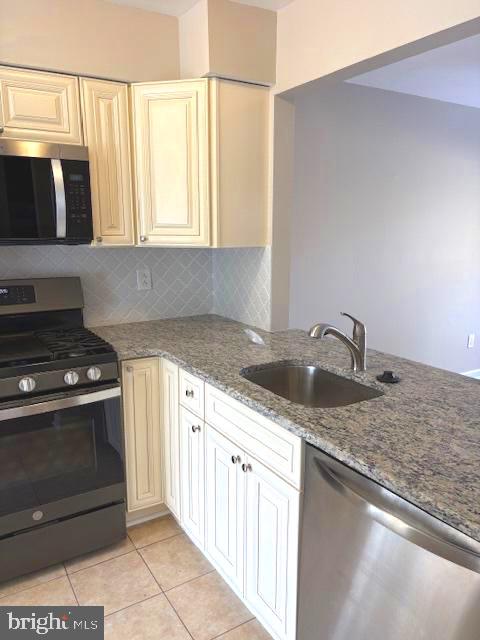 357 Brookdale Boulevard Williamstown, NJ 08094 - Photo 7 of 28 a kitchen with granite countertop a sink and a stove top oven
