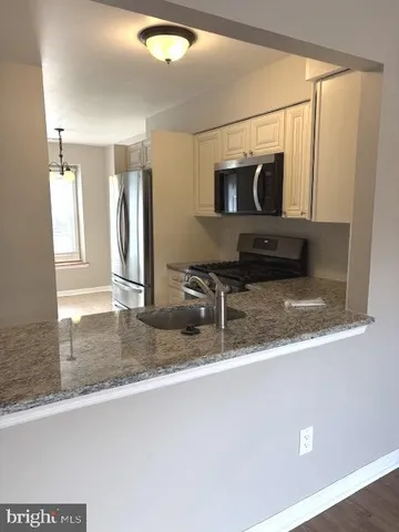 a view of living room with furniture and flat screen tv