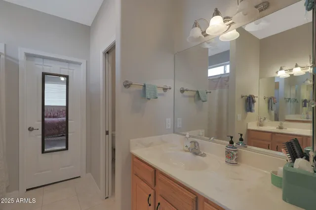 a bathroom with a sink a light fixture and a mirror