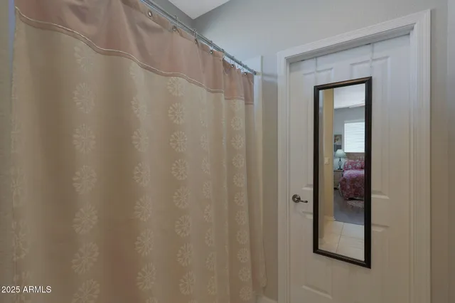 a view of walk in closet with clothes