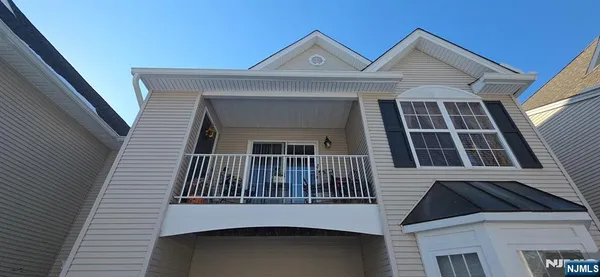 a view of a house with wooden fence