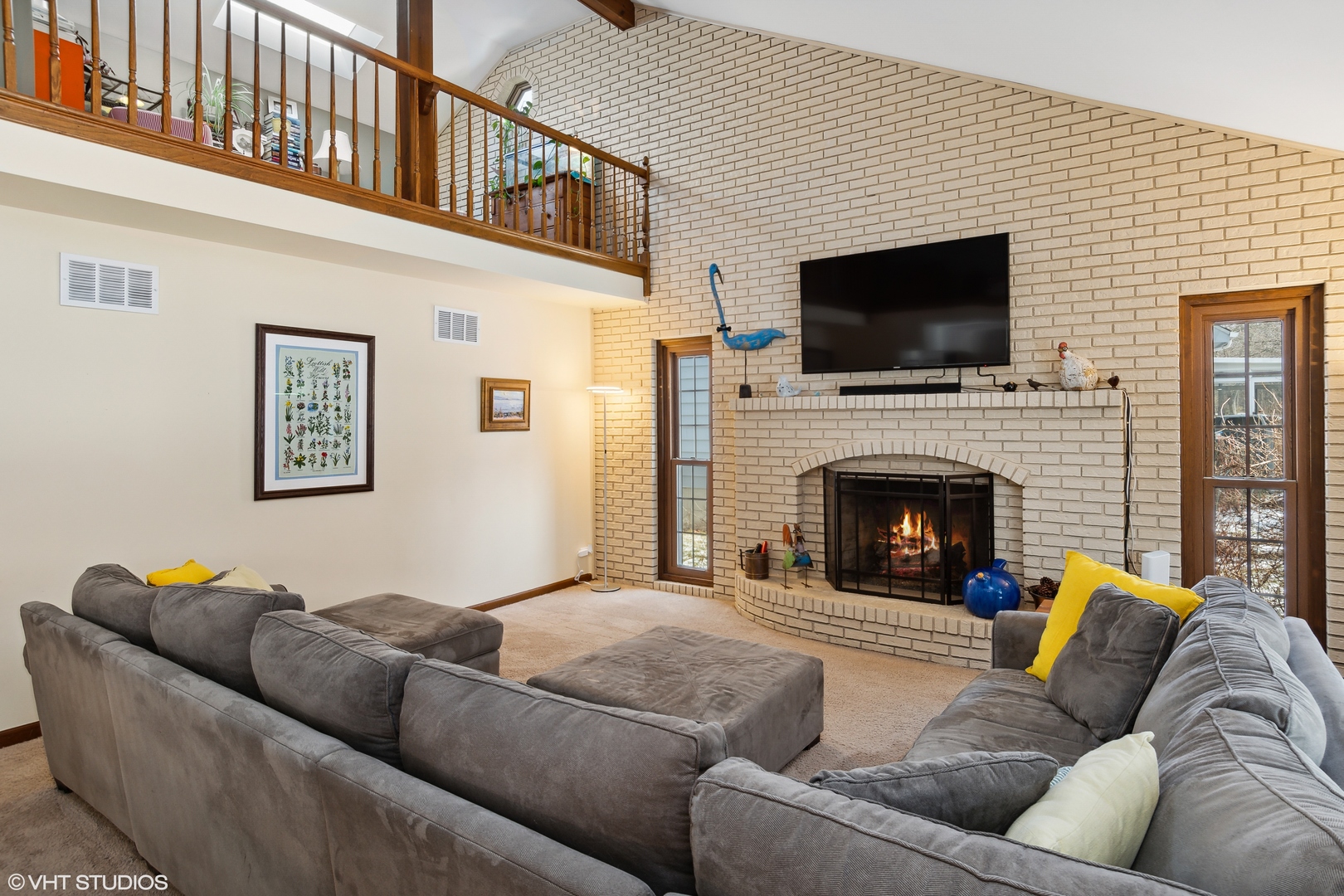 2661 Sun Valley Road Lisle, IL 60532 - Photo 8 of 26 a living room with furniture a flat screen tv and a fireplace