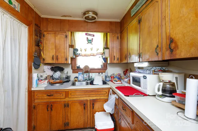 a kitchen with stainless steel appliances a sink a stove and white cabinets