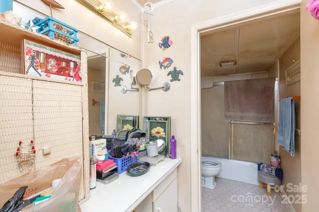 a view of bathroom with a sink mirror and toilet