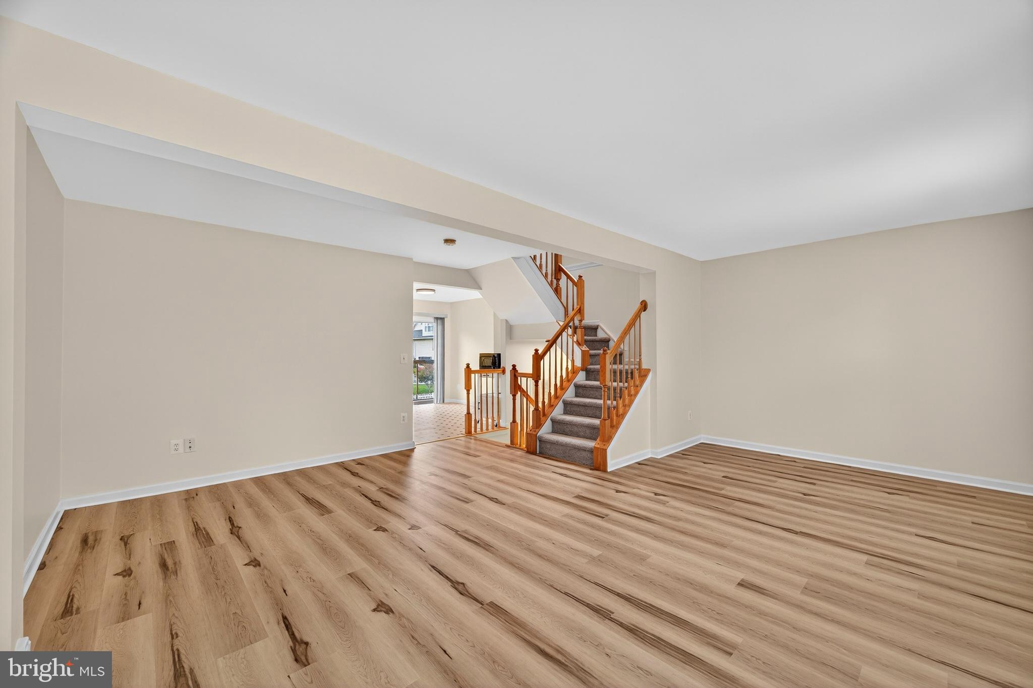 1337 Steed Street Ranson, WV 25438 - Photo 12 of 42 a view of an empty room with stairs and a ceiling fan