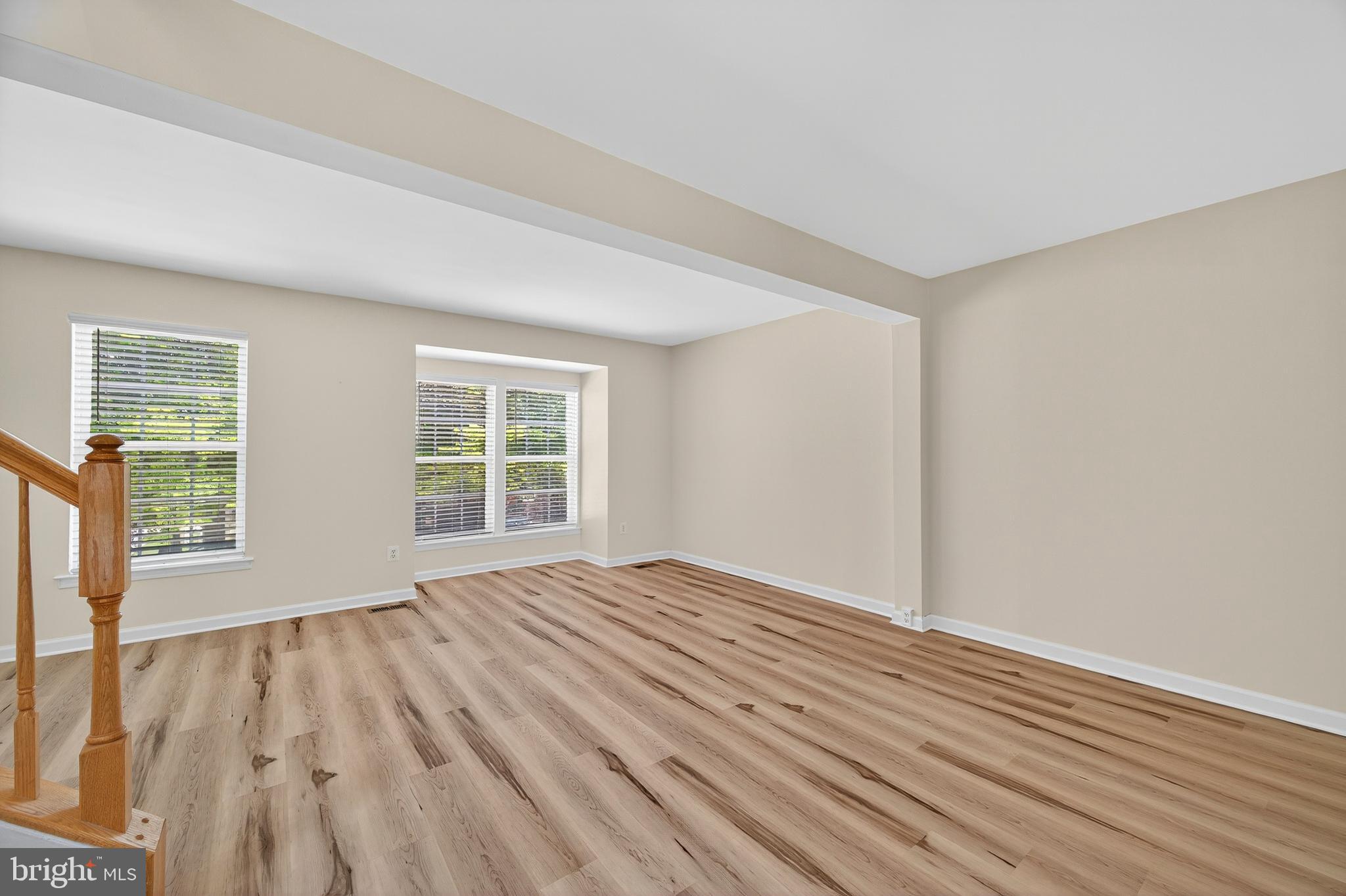 1337 Steed Street Ranson, WV 25438 - Photo 14 of 42 a view of an empty room with wooden floor and a window