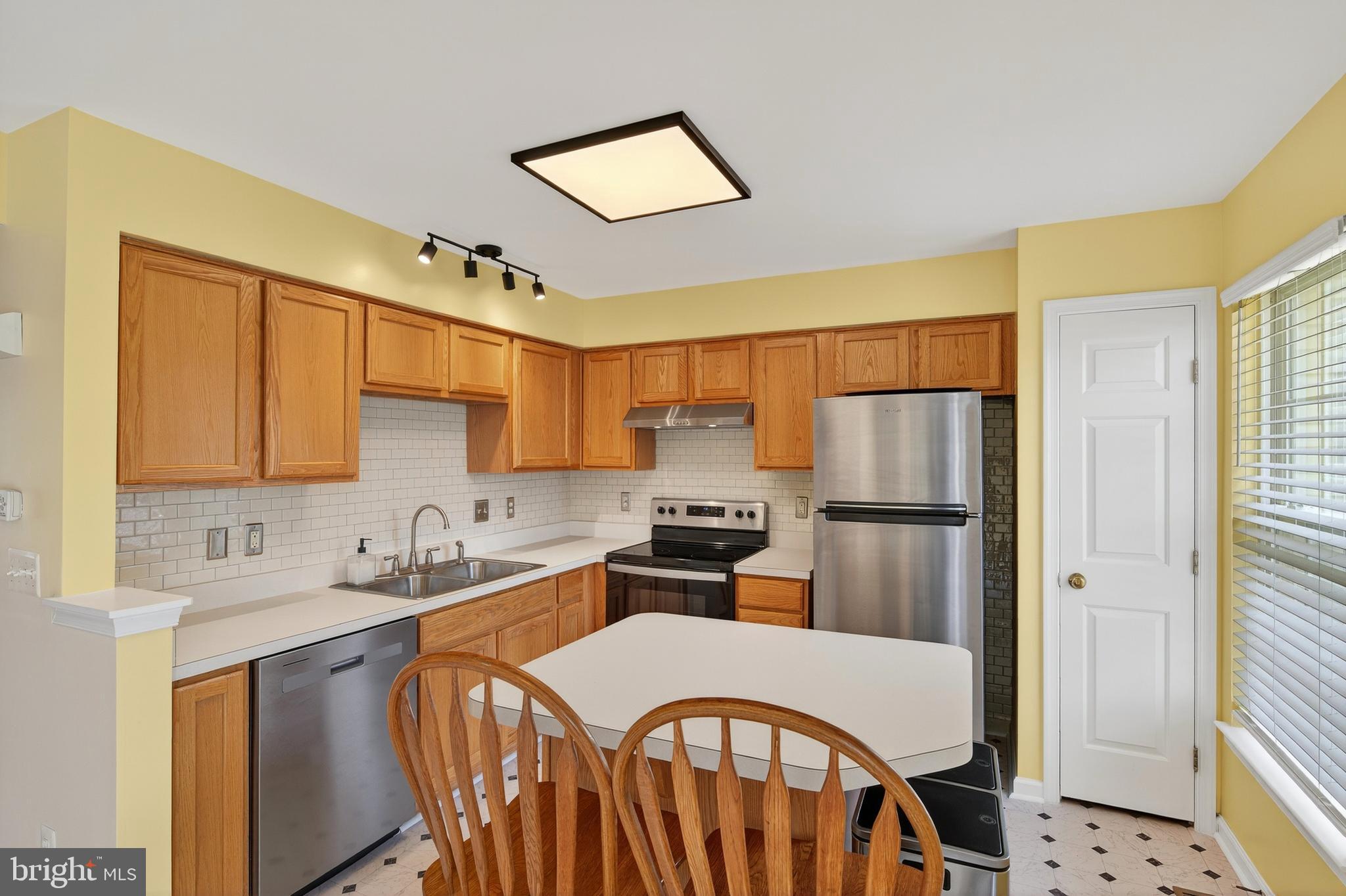 1337 Steed Street Ranson, WV 25438 - Photo 15 of 42 a kitchen with stainless steel appliances a refrigerator a sink a stove a table and chairs