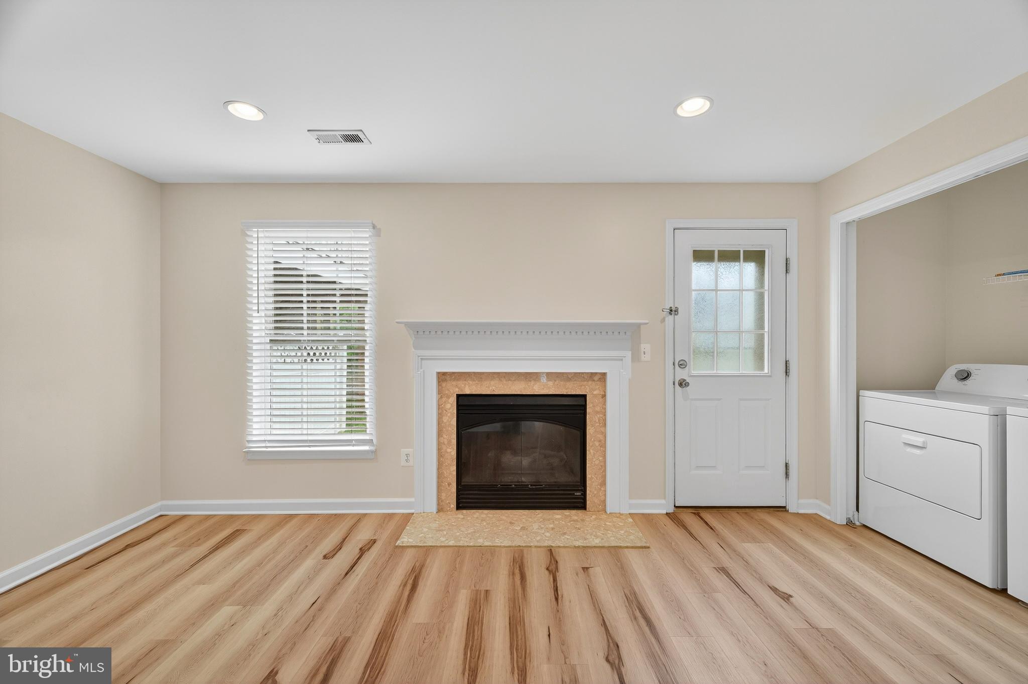 1337 Steed Street Ranson, WV 25438 - Photo 6 of 42 a view of empty room with a fireplace and wooden floor
