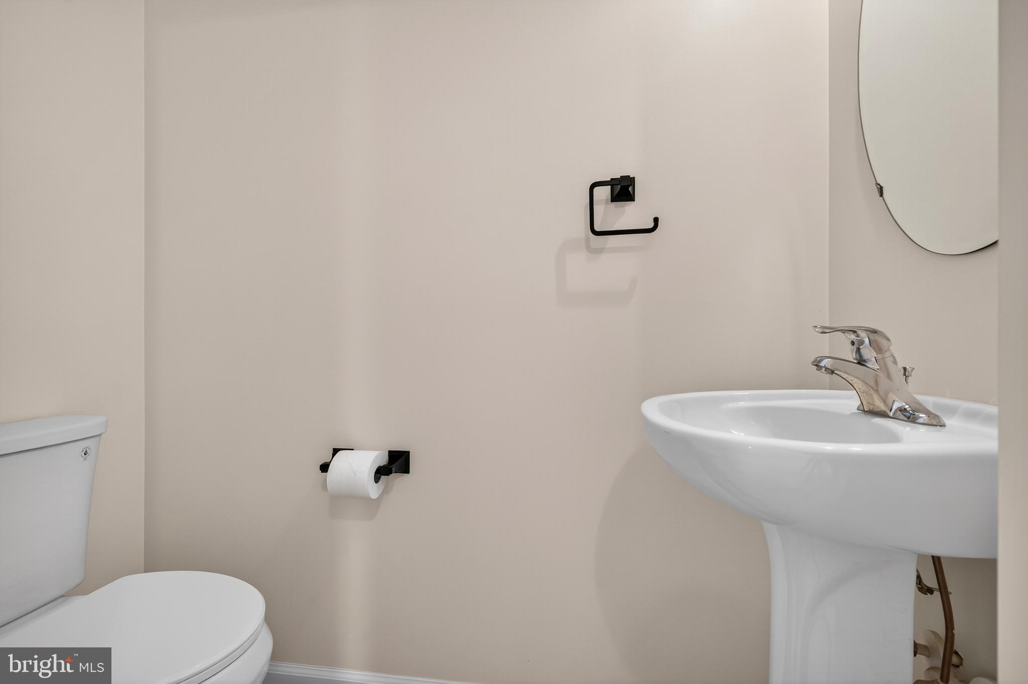 1337 Steed Street Ranson, WV 25438 - Photo 9 of 42 a bathroom with a sink a toilet and a mirror