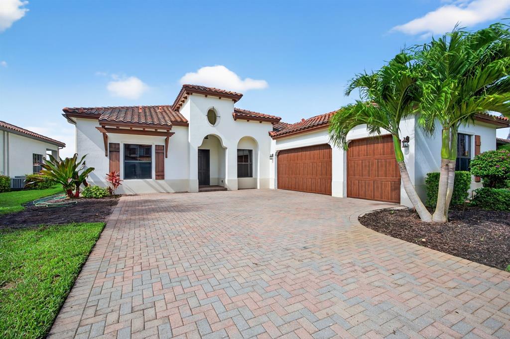 a front view of a house with a yard and a garage