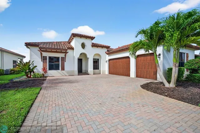 a front view of a house with a yard and a garage