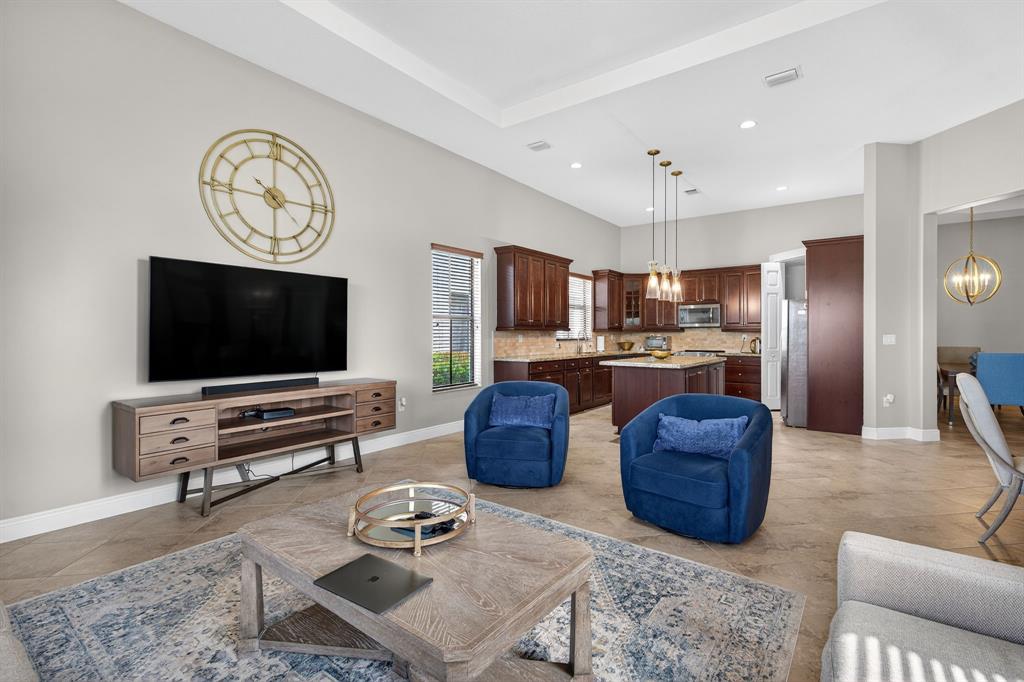 5294 Ferrari Avenue Ave Maria, FL 34142 - Photo 13 of 42 a living room with furniture and a flat screen tv
