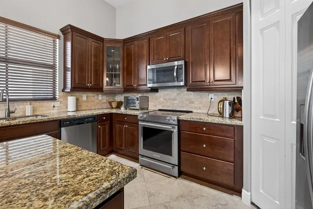 a kitchen with a sink and a stove top oven with wooden floor