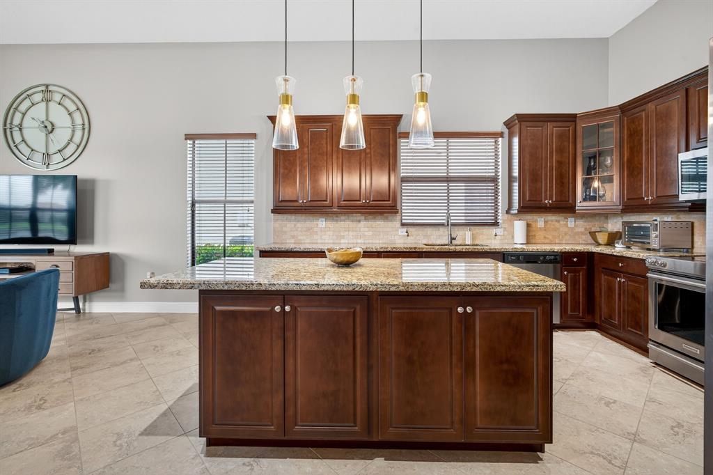 5294 Ferrari Avenue Ave Maria, FL 34142 - Photo 17 of 42 a kitchen with a sink and a stove top oven with wooden floor