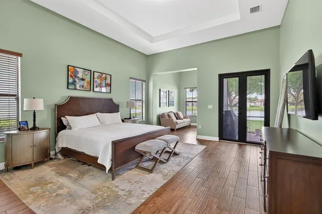 a bedroom with furniture and a wooden floor